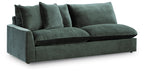 Jade green sectional sofa with rounded arms and three back pillows