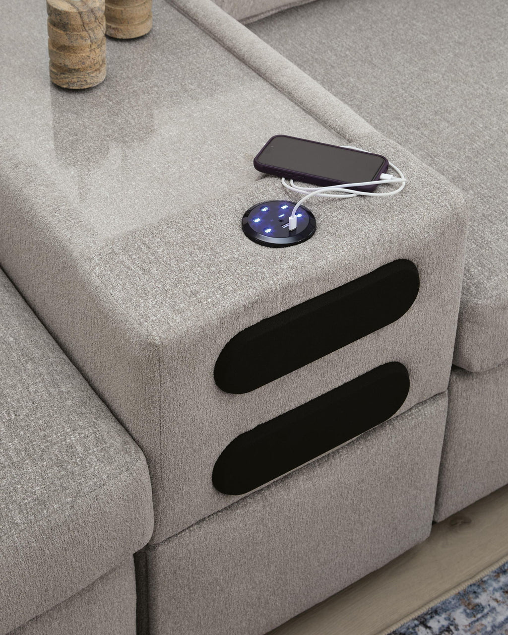 Gray sectional sofa chaise section with fabric storage opening on the arm