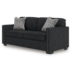 Coal fabric sofa with nailhead-trimmed sides and two heather gray throw pillows