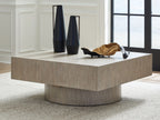 Light brown square table with textured wood surface and pedestal base