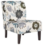 Accent chair with light base and blue-gray floral fabric, dark wooden legs.