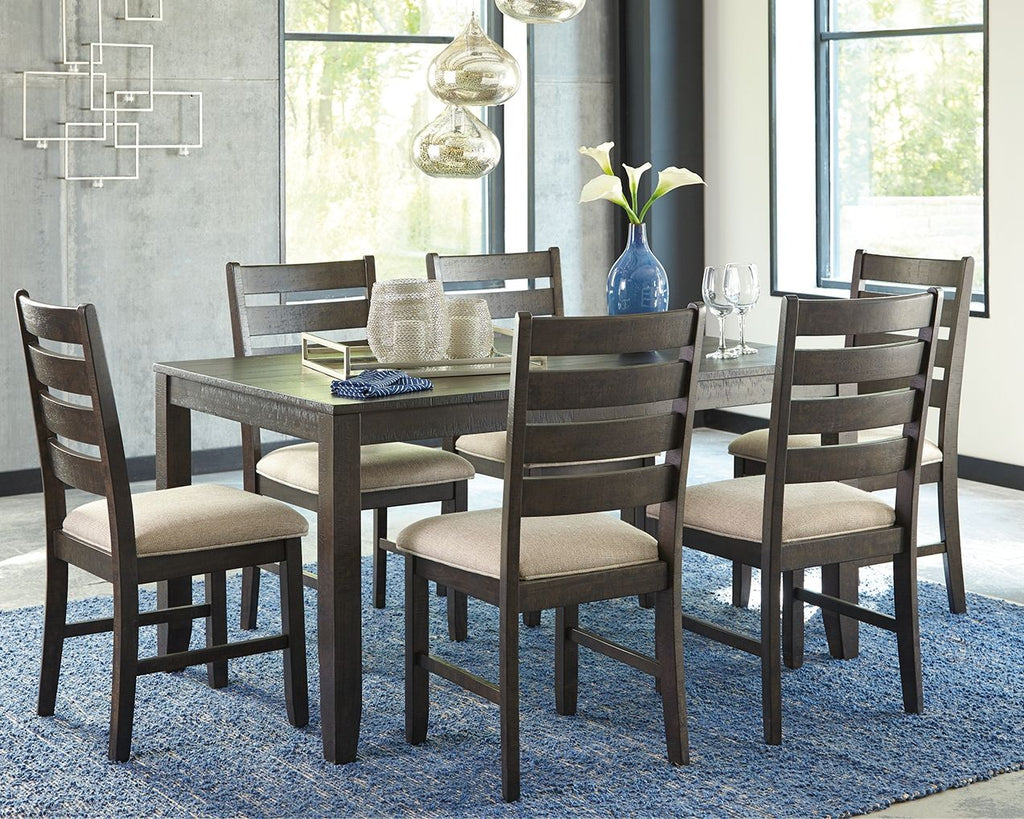 Brown dining table with six beige-cushioned chairs arranged for a meal