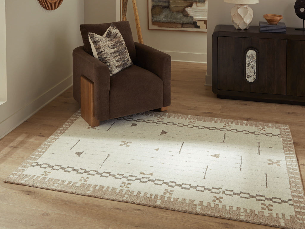 Light brown area rug with cream background and dark geometric border pattern