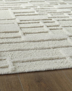 Empriss beige rug with stitched horizontal block lines and textured weave