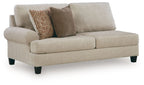 Latte fabric LAF sofa with two seat cushions, square arms, dark legs, and patterned throw pillows
