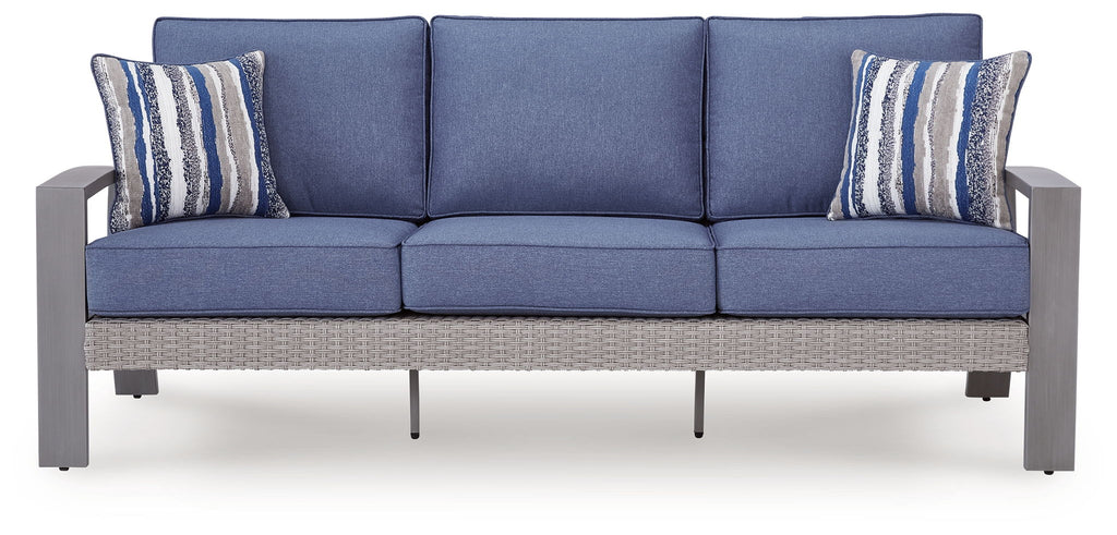 Blue outdoor sofa with gray frame, three seat sections and two striped throw pillows