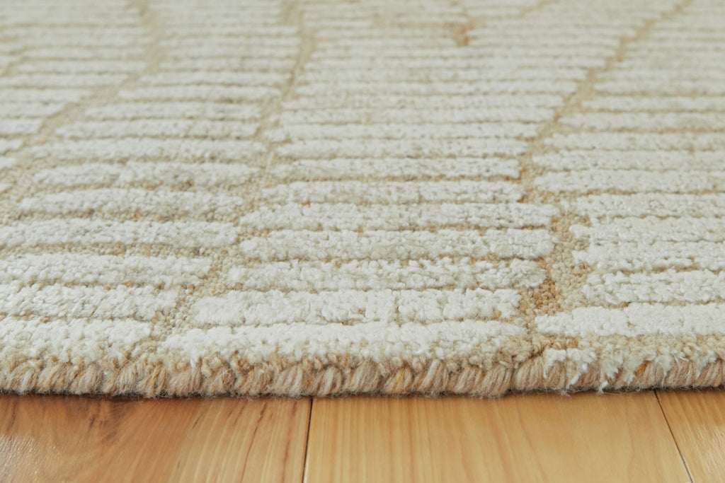 Beige rug close-up with textured loop weave and subtle wavy design