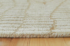Beige rug close-up with textured loop weave and subtle wavy design
