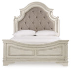 Upholstered panel bed with tufted beige headboard and white footboard, two pillows