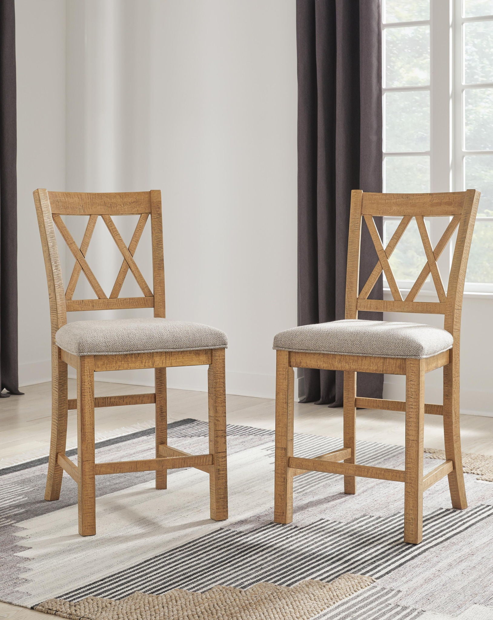 Pair of brown barstools with gray upholstered seats and X-shaped back panels