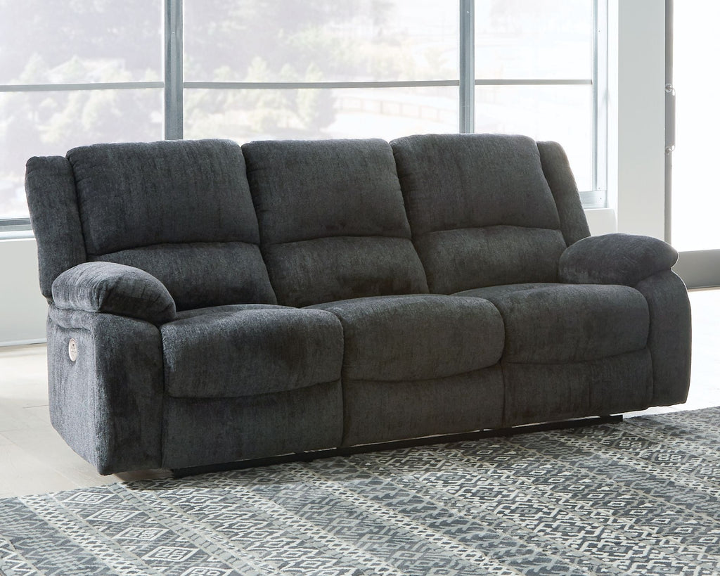 Draycoll reclining sofa in slate, high tufted back and padded recliner arms