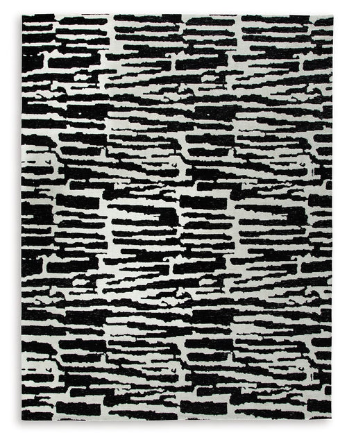Black-and-white abstract striped area rug with irregular horizontal block pattern