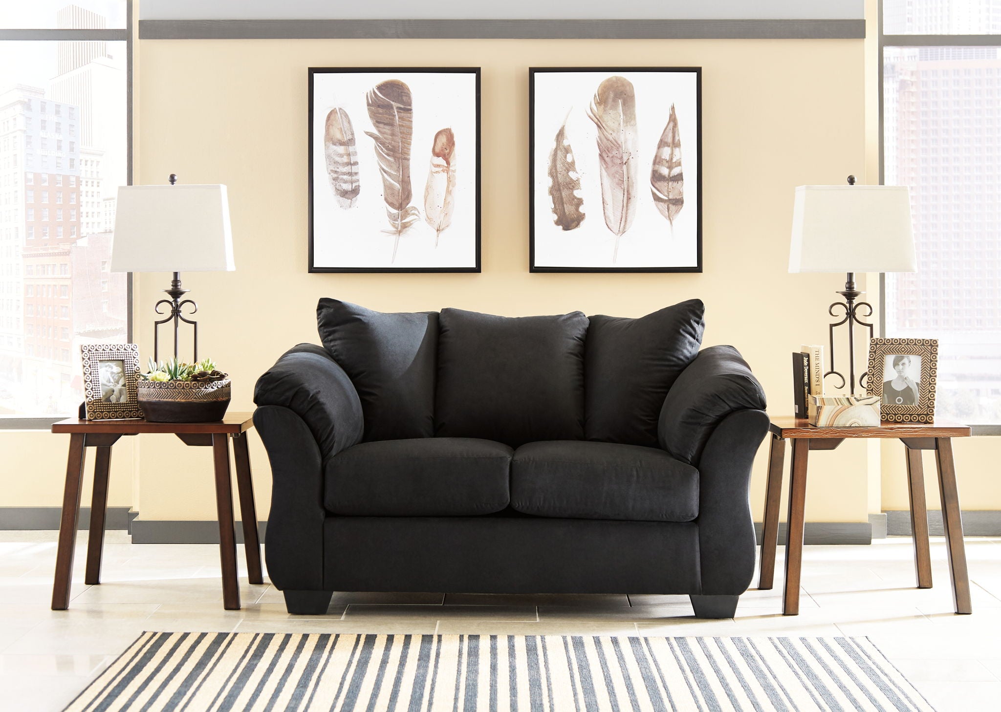 Darcy stationary loveseat in black fabric with rolled arms and two seat cushions