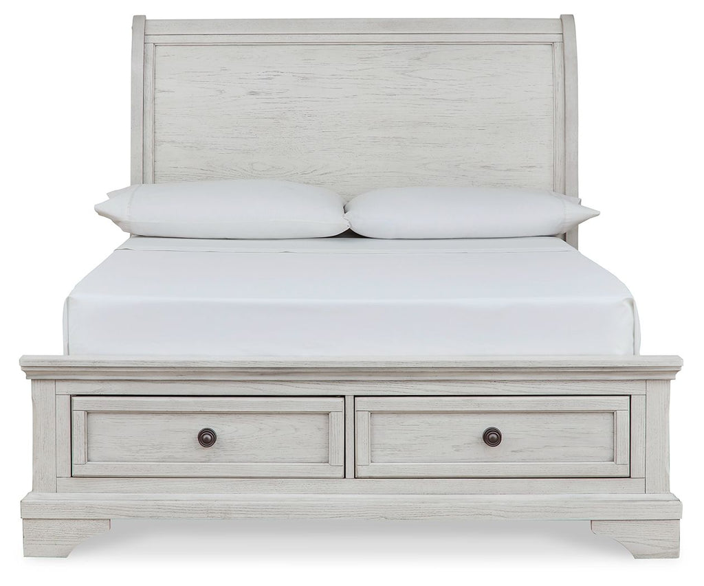 White sleigh bed with two drawers beneath and paneled headboard