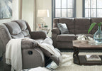 Gray reclining loveseat and armchair-style recliner with pillows, plush fabric