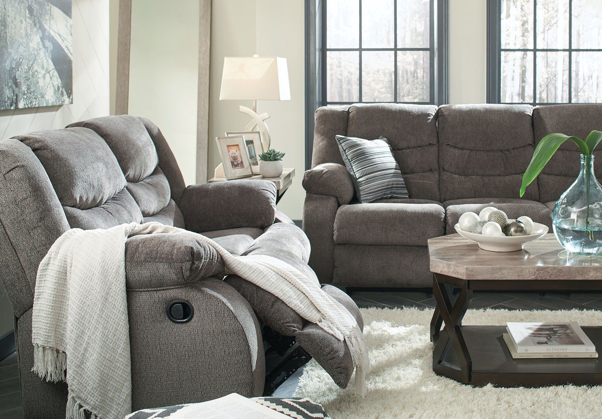 Gray reclining loveseat and armchair-style recliner with pillows, plush fabric