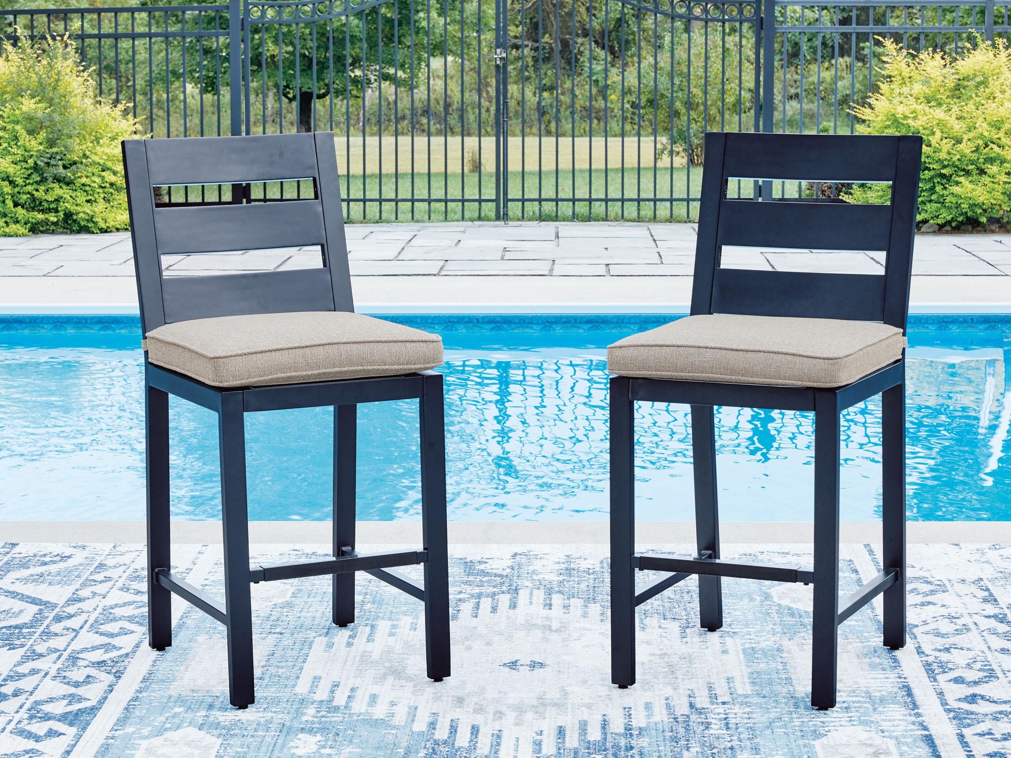 Set of 2 blue barstools with gray square cushions and footrest stretchers