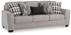 Gray flannel sofa with three upholstered seat cushions and patterned throw pillows