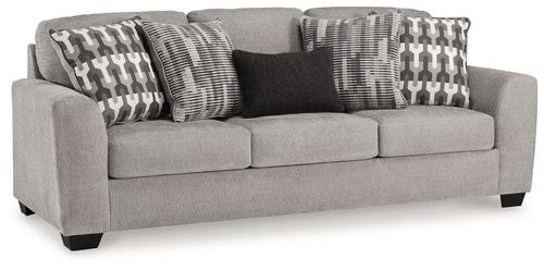 Gray flannel sofa with three upholstered seat cushions and patterned throw pillows