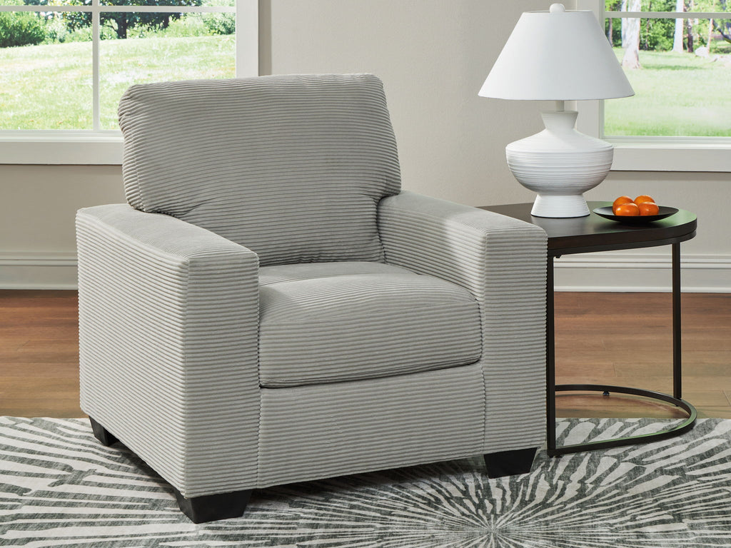 Upholstered armchair with striped fabric, wide armrests, and dark block legs in light gray.