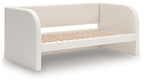 Upholstered day bed in beige fabric with white cushions; wooden slat base, no drawers