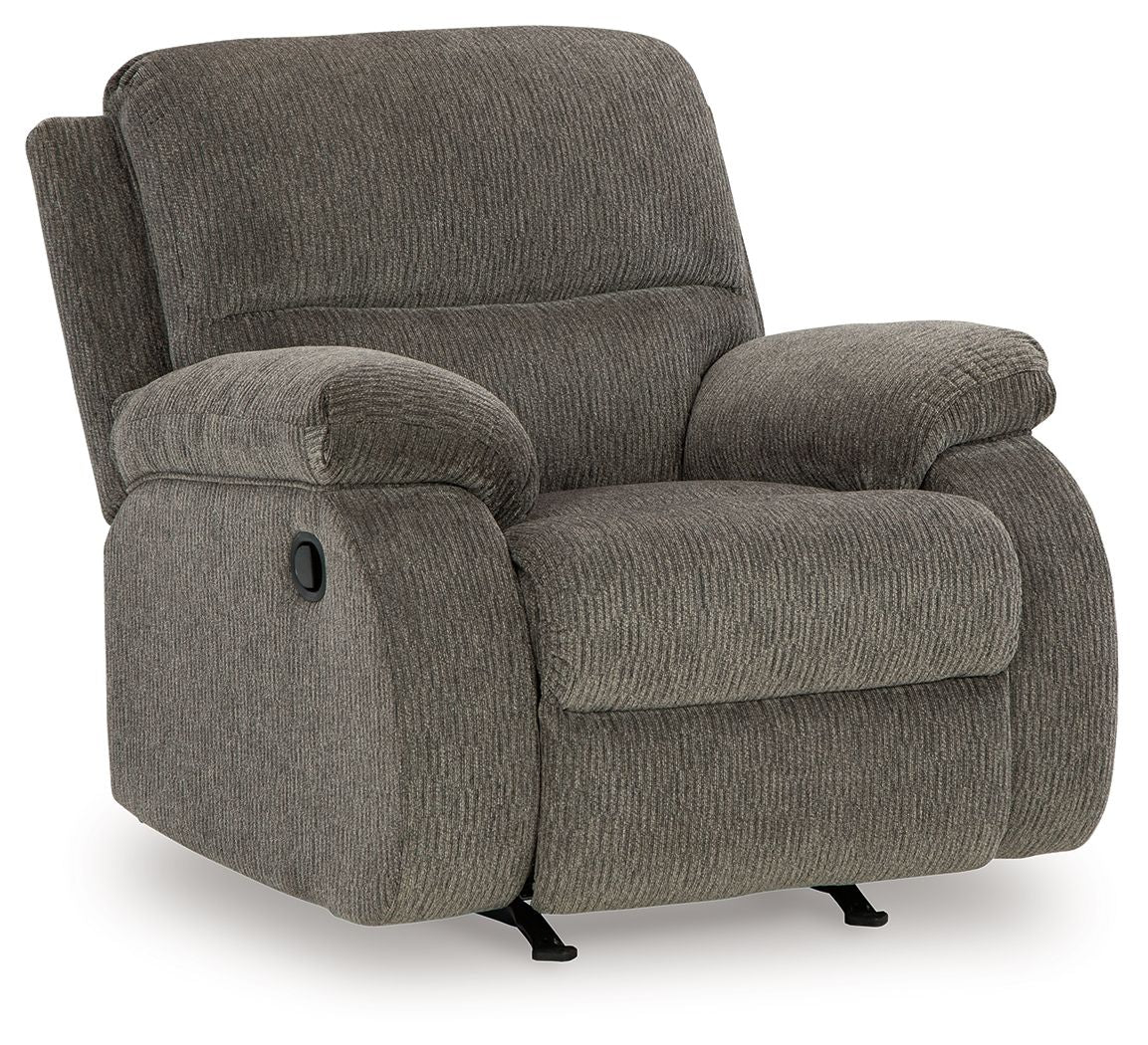 Dark gray rocker recliner chair with high backrest, rounded arm cushions, and base