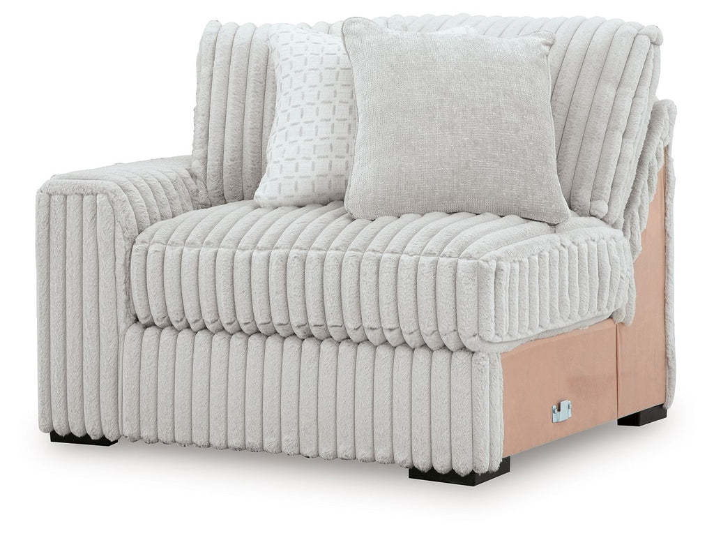 Upholstered corner chair with ribbed light-gray fabric, three cushions, and wooden base panel
