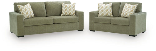 Bridgepoint living room set: green sofa and loveseat with patterned beige throw pillows