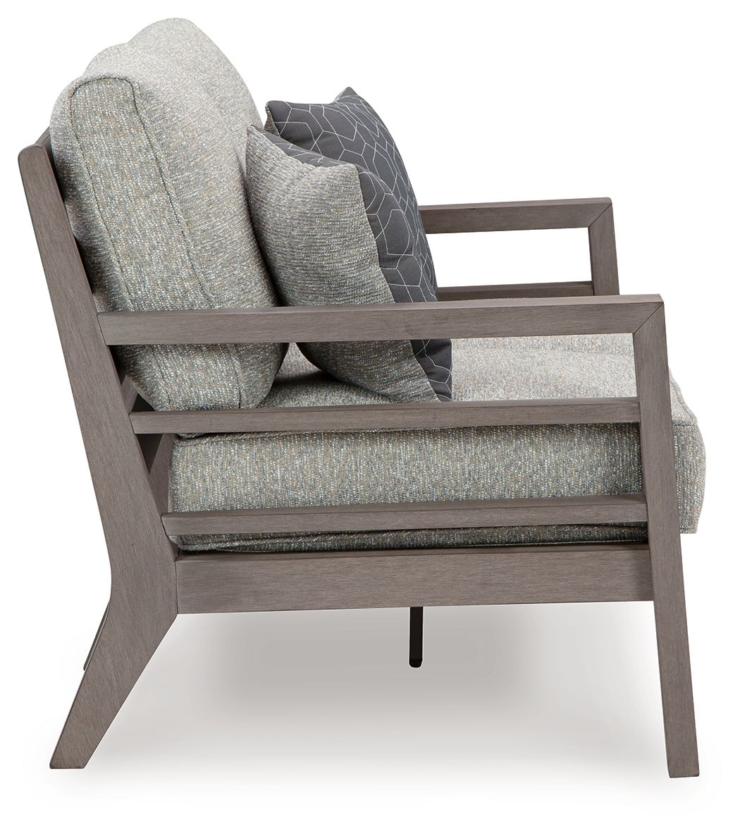Gray loveseat chair profile with back cushion, armrests, and patterned accent pillow