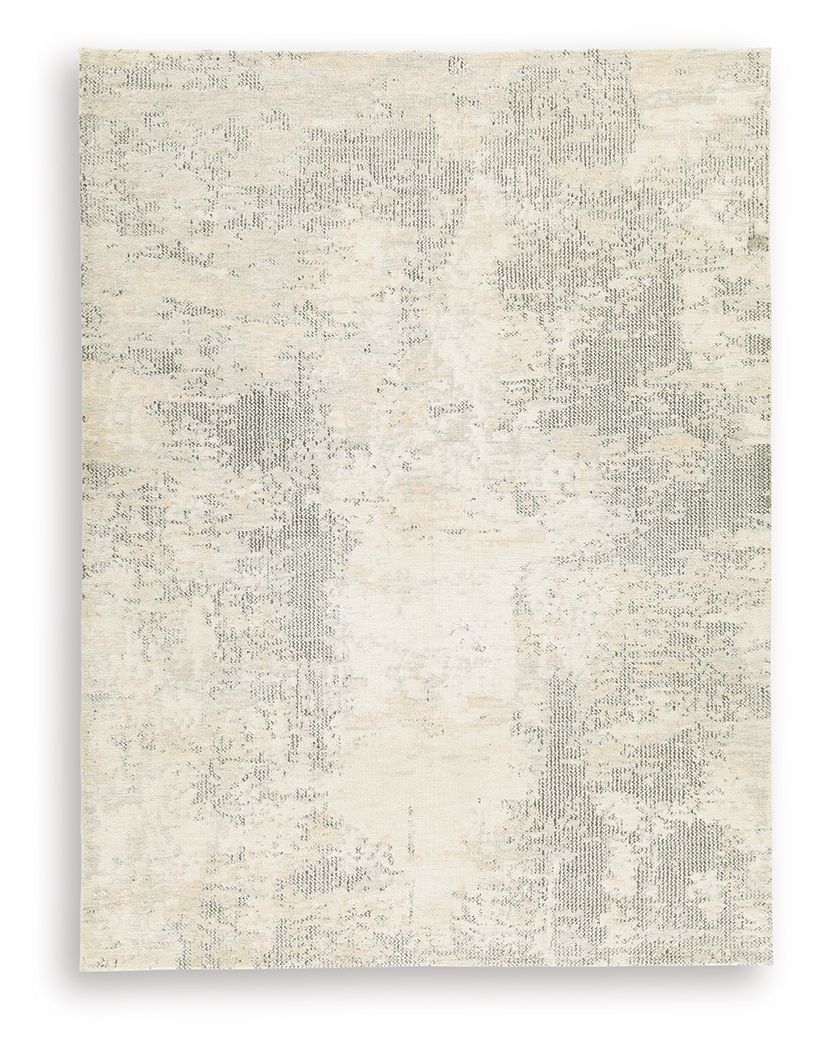 Cream area rug with subtle gray patchwork pattern and distressed texture
