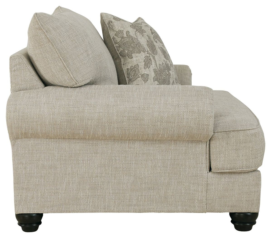 Light gray linen-style armchair side view with two throw pillows and cushioned seat