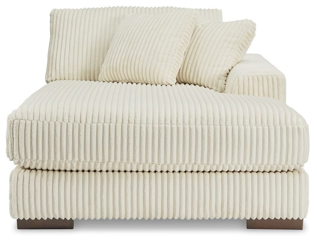 Ivory corner chaise sofa with thick seat padding and two striped back pillows