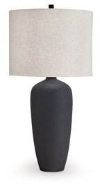 Black metal table lamp with beige fabric drum shade and dark base
