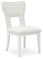 White upholstered dining side chair with curved back, open frame, and padded seat