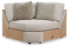 Wedge sectional sofa with light gray upholstered cushions and sturdy wooden base