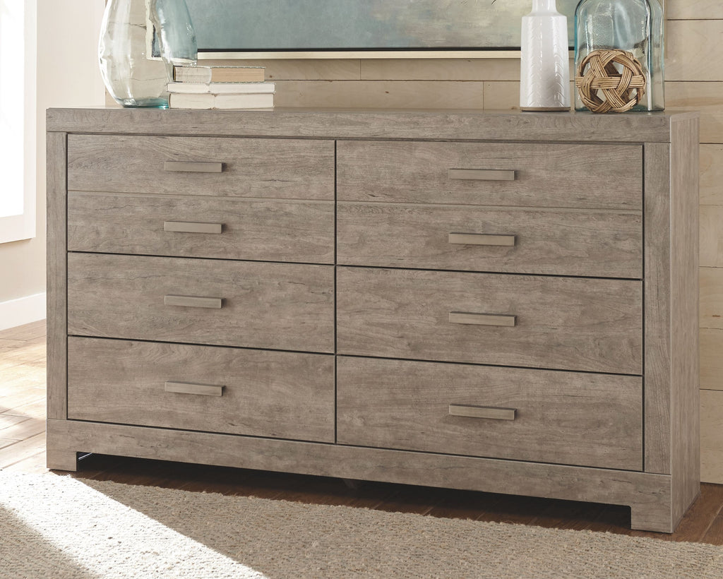 Gray panel dresser with multiple drawers and straight bar pulls