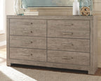 Gray panel dresser with multiple drawers and straight bar pulls