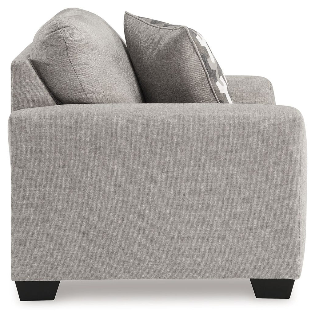 Gray upholstered chair with two throw pillows and square arms