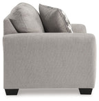 Gray upholstered chair with two throw pillows and square arms