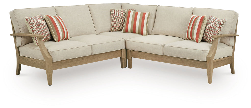 Beige outdoor sectional sofa with striped and patterned throw pillows