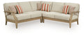 Beige outdoor sectional sofa with striped and patterned throw pillows