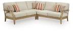 Beige outdoor sectional sofa with striped and patterned throw pillows