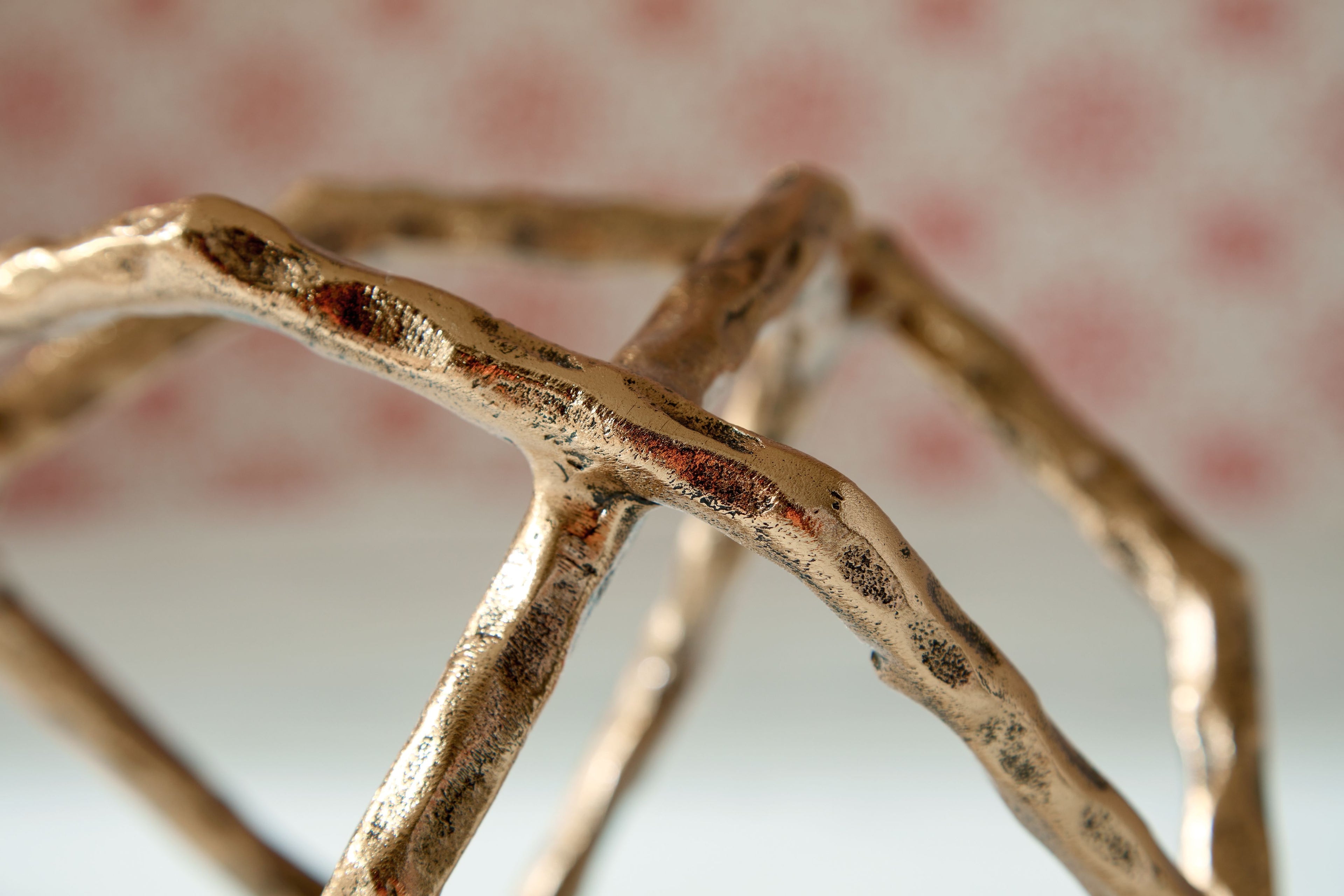 Laddington sculpture detail: textured light brown metal rods at the edge.