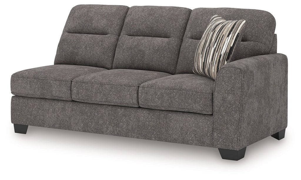Graphite gray fabric sofa with three back cushions and striped throw pillow