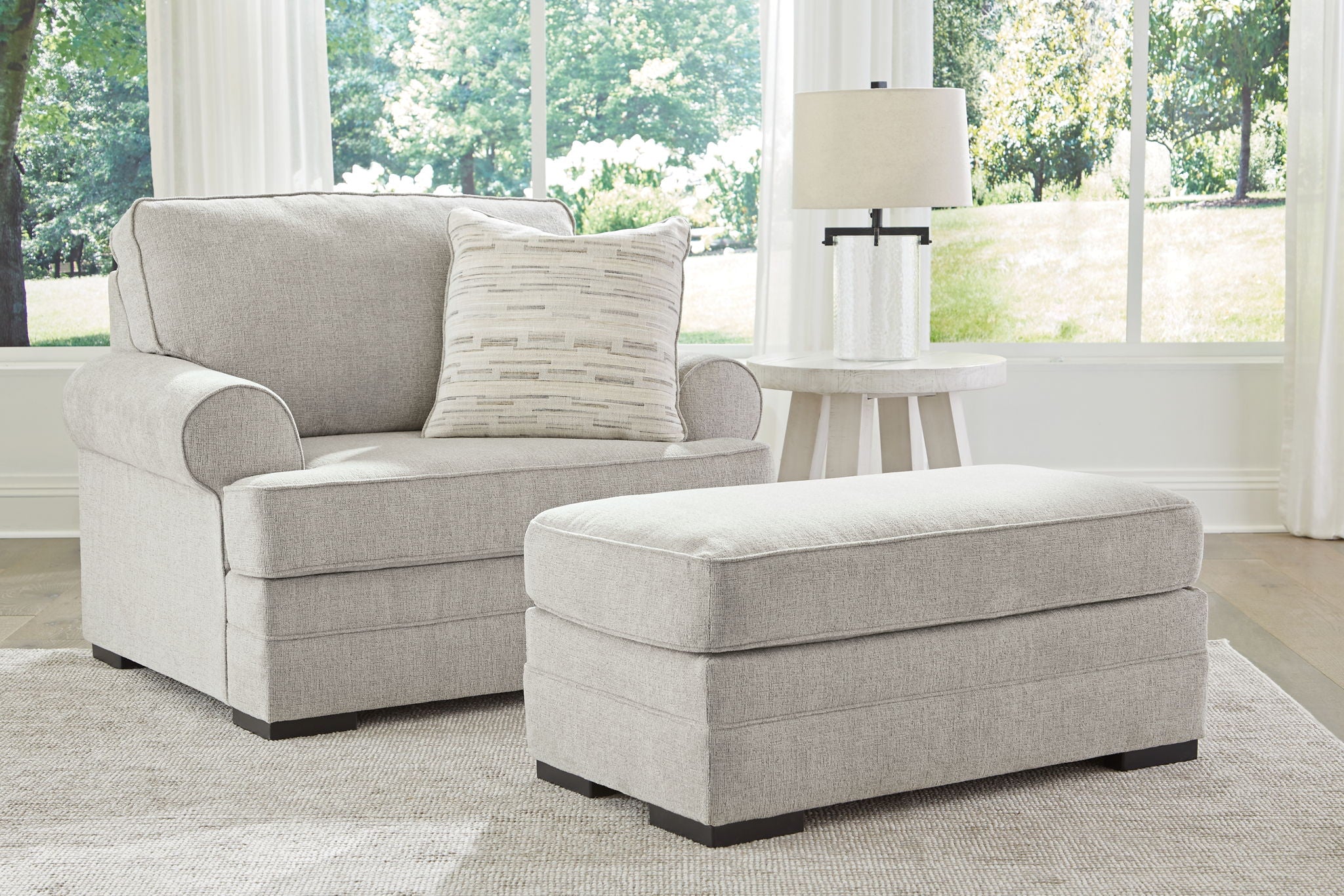 Gray sofa chaise with matching ottoman and throw pillows