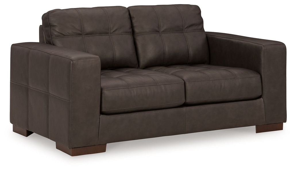Dark brown loveseat with tufted back cushions and wide padded armrests