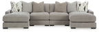 Gray sectional sofa with three ottoman-style seats and decorative patterned throw pillows