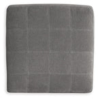 Square upholstered ottoman in gray with stitched grid pattern upholstery