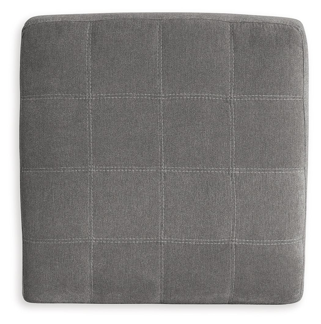 Square upholstered ottoman in gray with stitched grid pattern upholstery