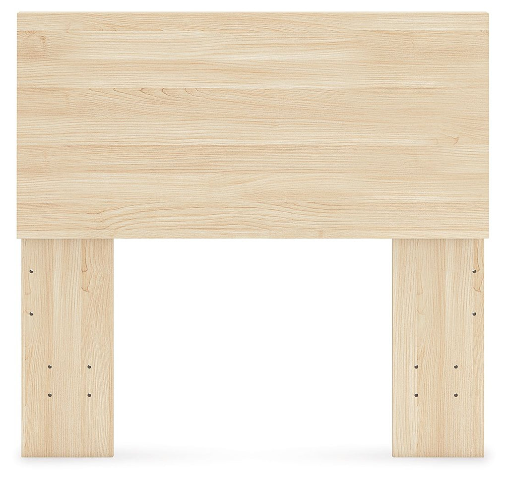 Light wood panel headboard with wide top panel and drilled side posts.